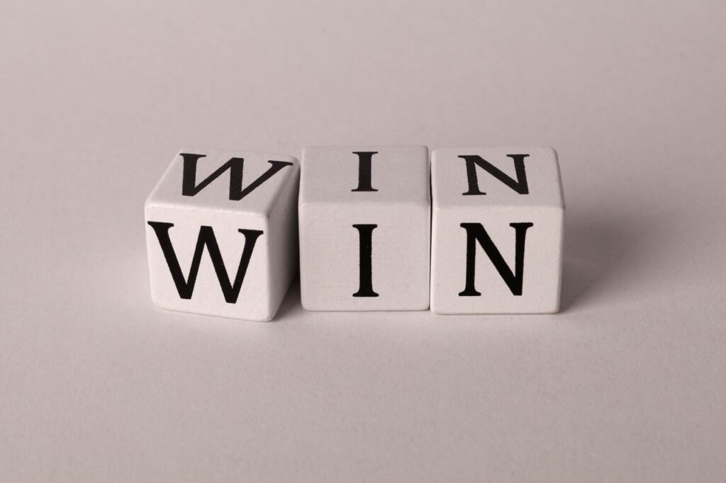 White cubes with the word 'WIN' against a light background symbolizing success and achievement.